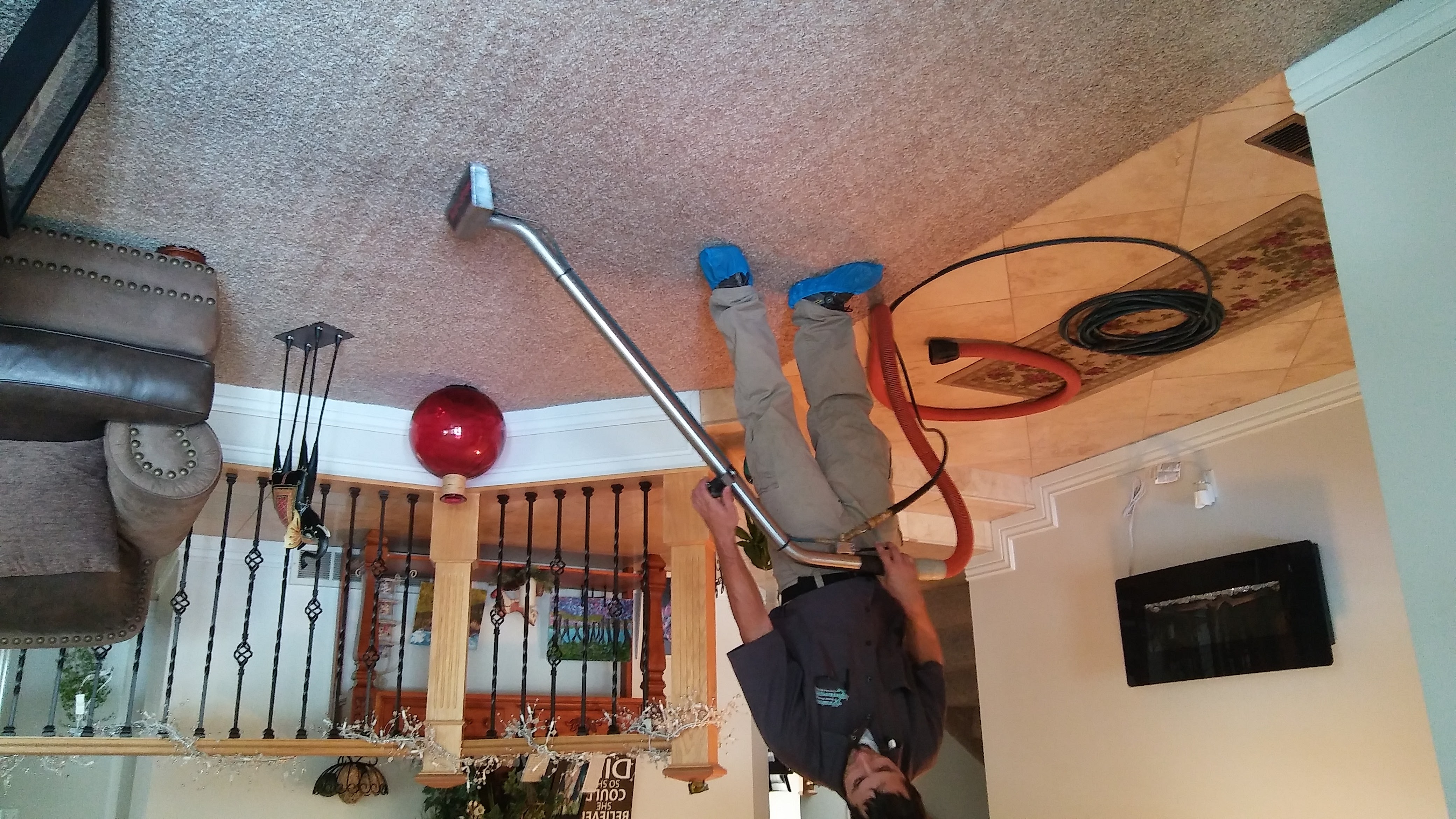 technician cleaning homeowners carpet with a hot steam extraction process